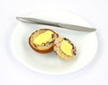 Buttered berry muffin on plate with knife Royalty Free Stock Photo