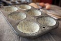 Buttered muffin tin with corn flour Royalty Free Stock Photo