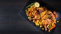 Butterflied grilled whole chicken with roasted vegetables and potatoes