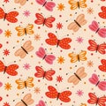 Cute simple butterflies and flowers seamless pattern in orange, red and pink with dots on light cream background. Royalty Free Stock Photo