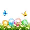 Butterflies flying over colored Easter eggs on grass