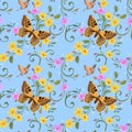 Butterfly and beautiful flowers on blue background seamless pattern. Royalty Free Stock Photo