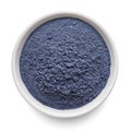 Butterfly pea flower powder or blue matcha in round bowl isolated on white. Top view Royalty Free Stock Photo