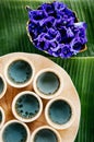 Butterfly Pea flower tea, Asian herbal flower tea seving in ceramic cups on banana leaves