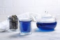 Butterfly pea flower tea is brewed in a glass teapot and served into a transparent cup. Blue herbal tea Royalty Free Stock Photo