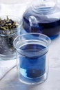 Butterfly pea flower tea is brewed in a glass teapot and served into a transparent cup. Blue herbal tea Royalty Free Stock Photo