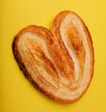 Butterfly puff pastry or palmier cookie on yellow Royalty Free Stock Photo