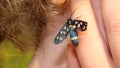 Butterfly sits on a man hand. Blue, fragile butterfly wings on man fingers create harmony of nature, beauty magic close-up. Macro.