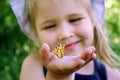 Butterfly sitting on the hand of a child. Child with a butterfly. Butterfly painted lady on the hand of a little girl. Selective f