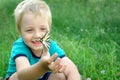 Butterfly sitting on the hand of a child. Child with a butterfly. Butterfly on the hand of a little boy. Selective focus. Royalty Free Stock Photo