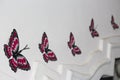 butterfly stickers on the wall of a house. Size of the art is made gradualy decreased as it moves away