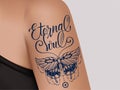 Butterfly tattoo on female shoulder. Mystic butterfly tattoo with lettering Eternal Soul.