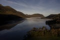 Dawn mist rises around Buttermere, the lake in the English Lake Distric