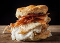 Buttermilk biscuit and fried chicken breast sandwich with a fried egg and bacon Royalty Free Stock Photo