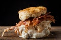 Buttermilk biscuit and fried chicken breast sandwich with a fried egg and bacon Royalty Free Stock Photo