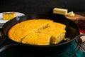 Buttermilk Cornbread Baked Cut Into Pieces in a Cast-Iron Skillet