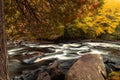 Buttermilk Falls in Long Lake, NY, Adirondacks, surrounded by vivid fall foliage on an overcast afternoon Royalty Free Stock Photo