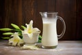 buttermilk in a glass pitcher, white lilies on the side