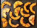 Butternut squash bright orange pieces grilled on electric grill, view from above