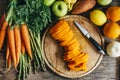 Butternut squash, carrots, sweet potato, oranges, apples, carrots and asparagus on cutting board overhead. Top view of healthy bio Royalty Free Stock Photo