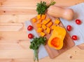 Butternut squash,  pumpkin pieces, fresh parsley and tomatoes on wooden table. Top view, copy space Royalty Free Stock Photo