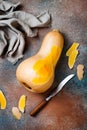 Butternut squash on rustic background. Healthy fall cooking concept.