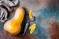 Butternut squash on rustic background. Healthy fall cooking concept.