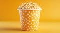Buttery Popcorn in a Yellow Paper Cup Royalty Free Stock Photo