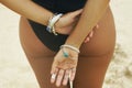 Buttocks and hands with silver bracelets