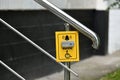 Button for calling help for disabled on handrail of the stairs, Russia Royalty Free Stock Photo