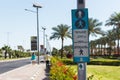 Button for calling the pedestrian crossing with the up arrow. click here to cross it written in four languages English, Arabic, Ru