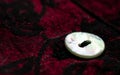 Button on dark-red fabric Royalty Free Stock Photo