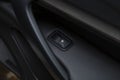 The button of the electric window of the car.An internal accessory of the car