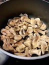 Button mushrooms frying in a pan Royalty Free Stock Photo