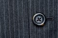 Button on a pin striped suit Royalty Free Stock Photo