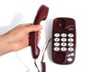 Female hand holds a telephone receiver on weight, on a white isolated background