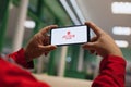 Button on the screen of a mobile phone. A man watches a live broadcast on a smartphone screen