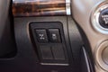 The button for the stability control system and locking the center differential on black panel of car near the steering wheel to Royalty Free Stock Photo