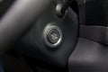Button start and turn off the ignition of the car engine close-up on the dashboard, electric key, of modern design black and with