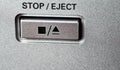 Button to stop and eject with symbols on the control panel.