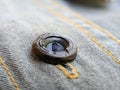 Button on a vintage dull brown shirt close up Royalty Free Stock Photo