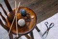Button and yarn ball on wooden chair