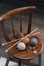 Button and yarn ball on wooden chair