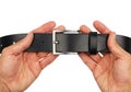 Buttoned black leather belt in hands, isolated
