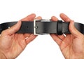Buttoned black leather belt in hands, isolated Royalty Free Stock Photo