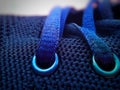 Buttonholes and laces of a blue shoe with a pores fabric texture Royalty Free Stock Photo