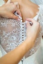 Buttoning the dress on bride, details of beautiful lace wedding dress Royalty Free Stock Photo