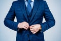 Buttoning up male vested blue suit with tie in formal fashion style grey background, formalwear Royalty Free Stock Photo