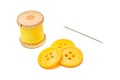 Buttons and spool of yellow thread on white Royalty Free Stock Photo