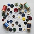 Buttons and wooden spools of thread are arranged on a textured Royalty Free Stock Photo